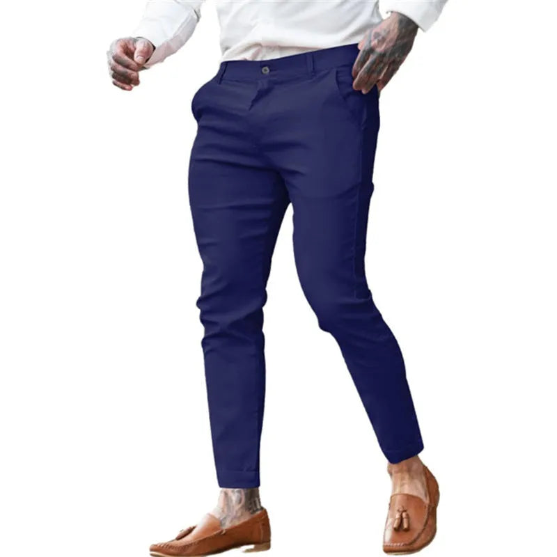 Men's slim fit elastic cotton pencil trousers in a solid colour on a hanger, showing the zip fly and mid waist design.