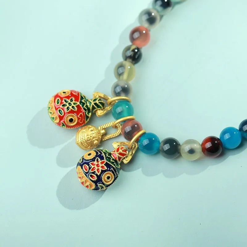 Women's natural agate bracelet with copper coin snake elements in geometric design