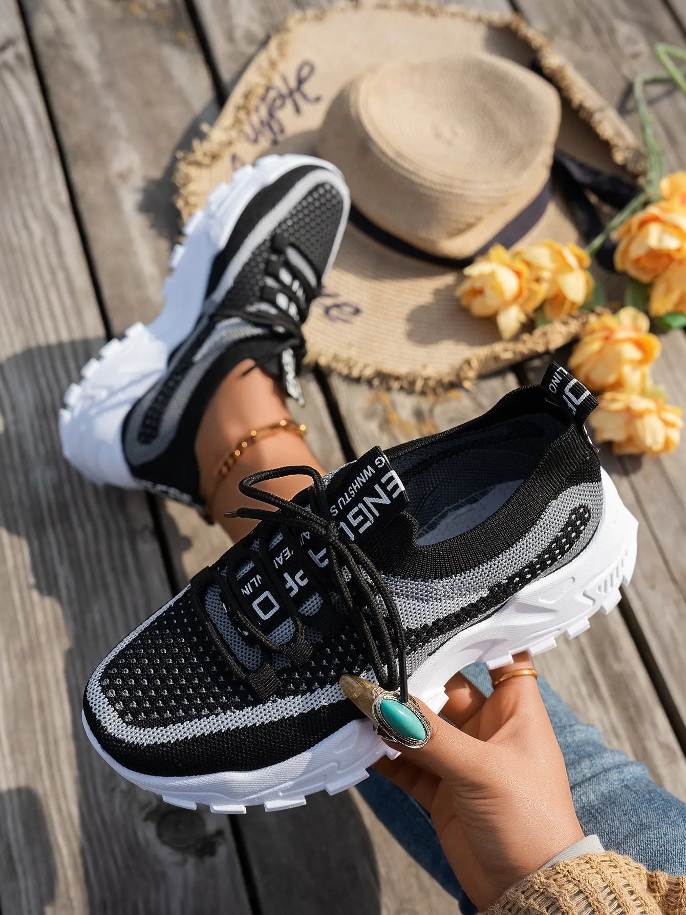 Women's Flyknit mesh lace-up sneakers in a grey colourway on a white background