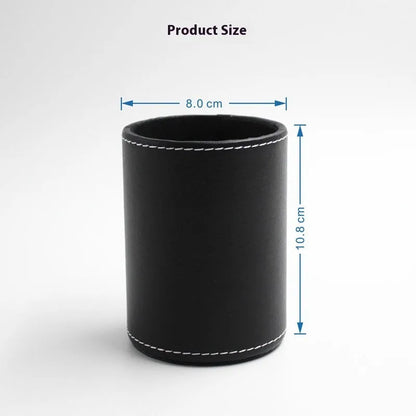 Round black leather pen container measuring 8.0cm diameter by 10.8cm height on wooden desk