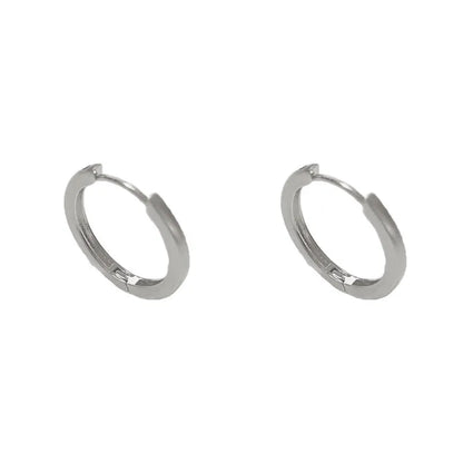 Geometric women's ear clip with round eyelet design in gold or silver colour