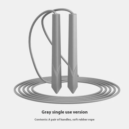Blue PVC skipping rope with plastic handles on a grey background.