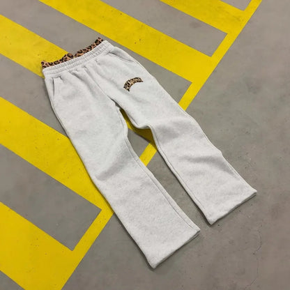 Men's patchwork double waist loose trousers with elastic polyester fabric for sports, showing zip placket closure and loose leg fit