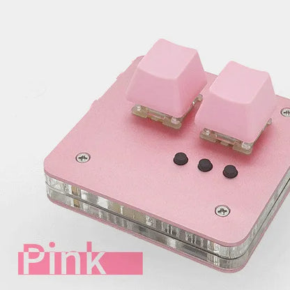 Mini white plastic USB wired keyboard with multimedia keys on a desk.