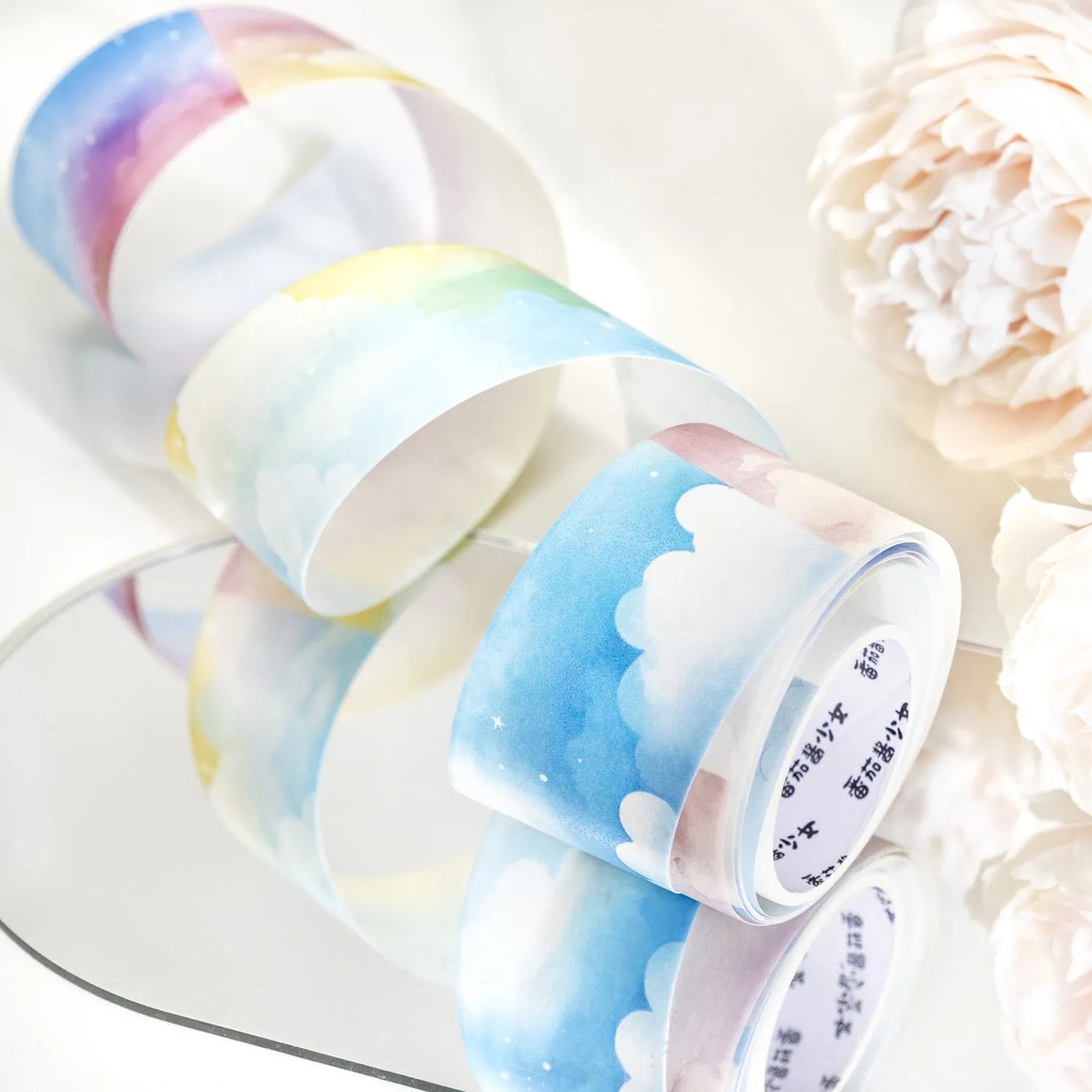 Roll of Japanese paper sky theme washi tape showing colourful clouds design, 30mm width