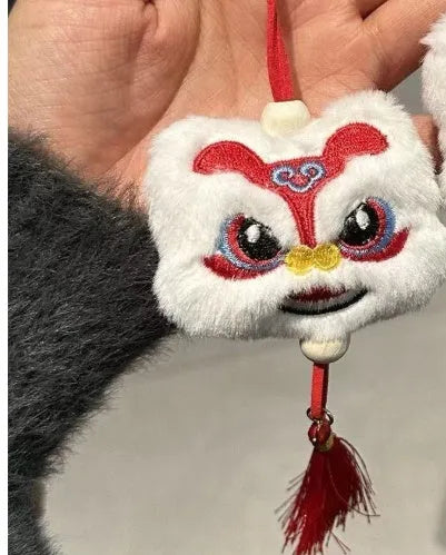 Blue and yellow Chinese style plush lion keychain ornament with star stone eyes and tassel.