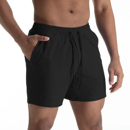 Man wearing black quick-dry polyester sports shorts suitable for running or gym workouts.