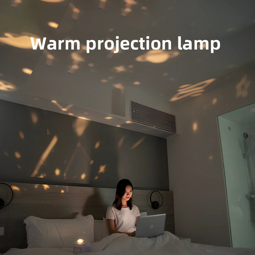 White portable humidifier with rotating projection light showing blue illumination and dual spray mist output