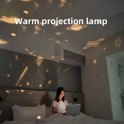 White portable humidifier with rotating projection light showing blue illumination and dual spray mist output