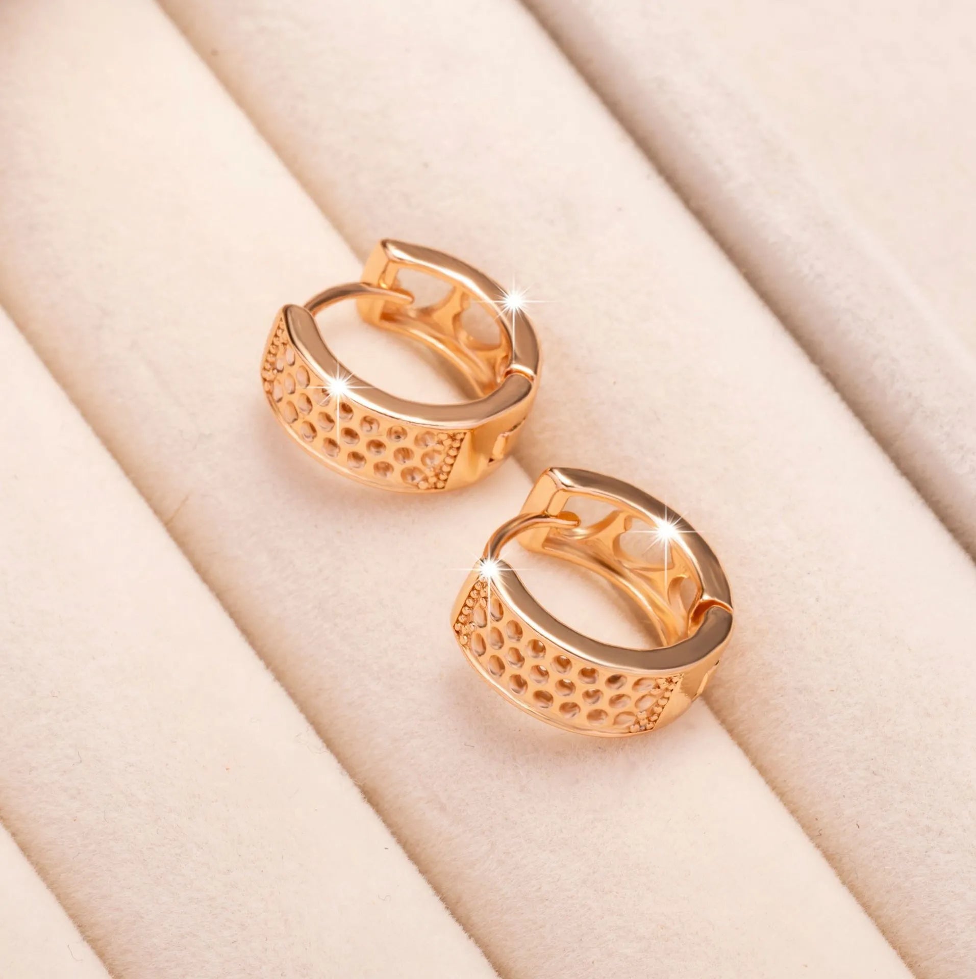Rose gold electroplated earrings with 2.5cm circular design and three heart-shaped cut-outs