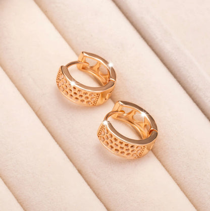 Rose gold electroplated earrings with 2.5cm circular design and three heart-shaped cut-outs