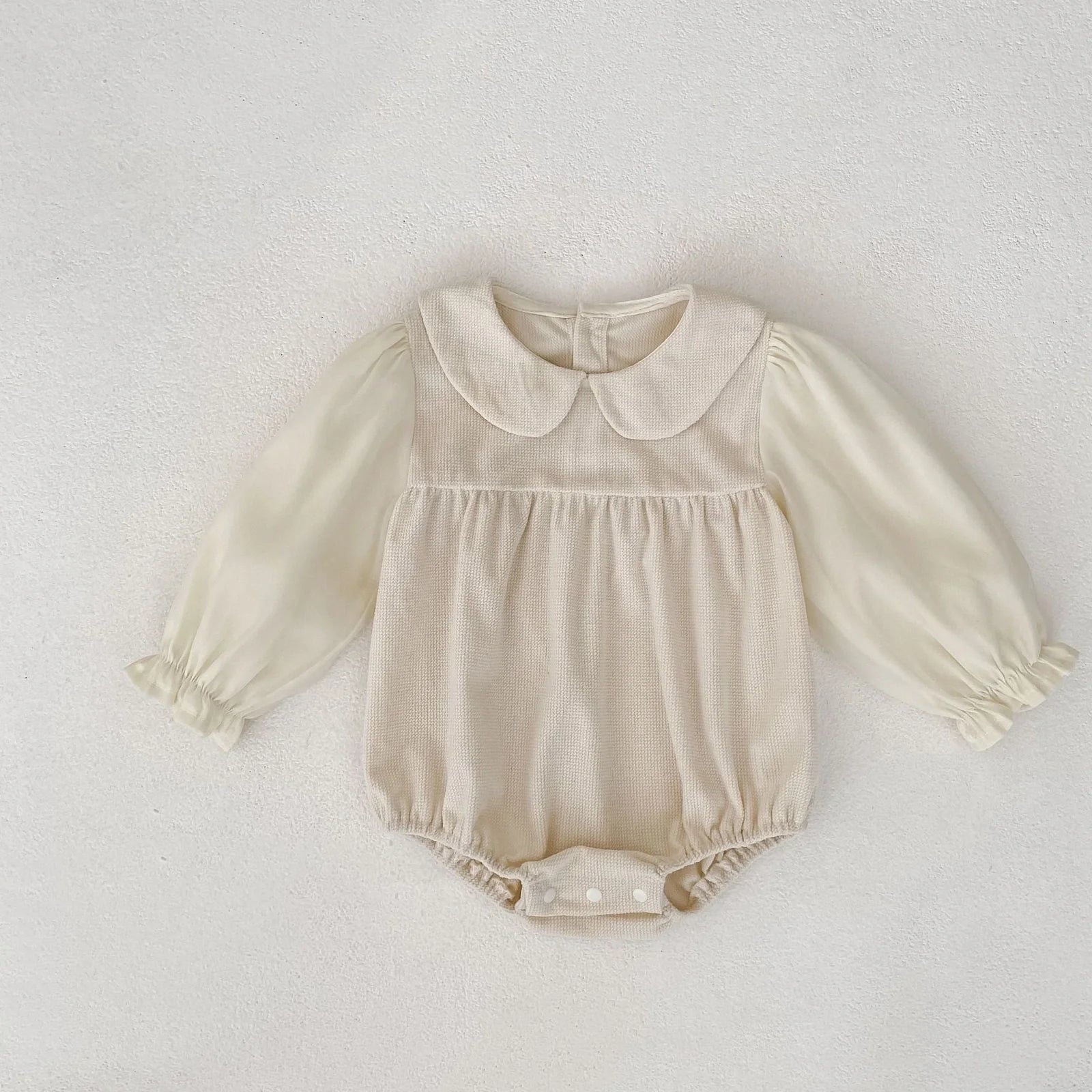 Corduroy doll collar long sleeve baby romper in black or apricot with single-breasted closure