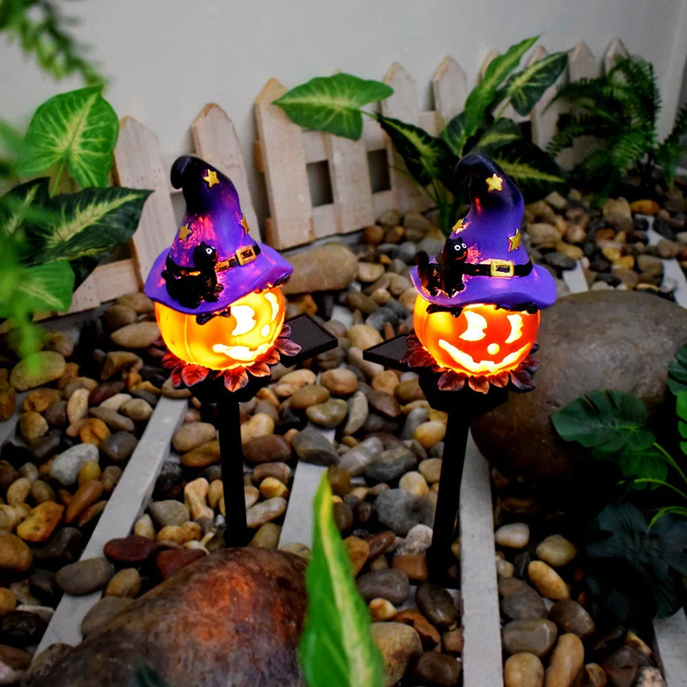 Solar-powered Halloween pumpkin lanterns lighting up a garden at night