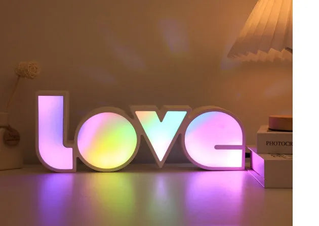 Rainbow halo LED love light with 'LOVE' word decoration on plastic casing.