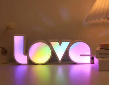 Rainbow halo LED love light with 'LOVE' word decoration on plastic casing.