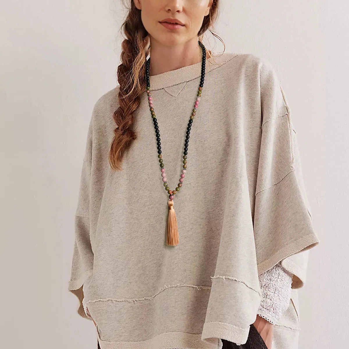 Long beaded necklace with geometric pendant and natural stone tassels in green aventurine.