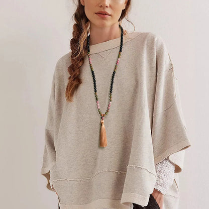 Long beaded necklace with geometric pendant and natural stone tassels in green aventurine.