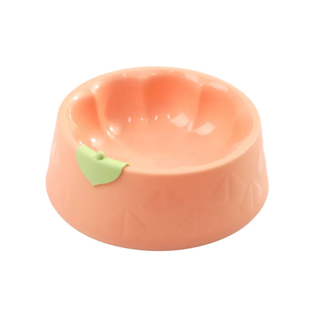 Green plastic double pet bowl with two compartments for food and water on a flat surface.