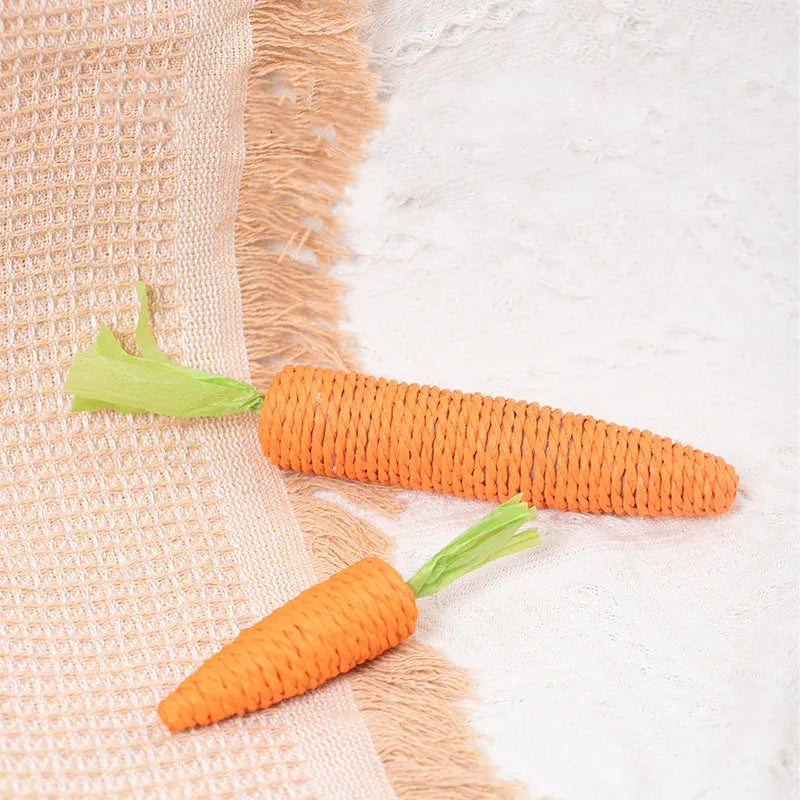 Set of interactive cat toys including carrot bites, paper toys, ringing stones, and sticks in two sizes.