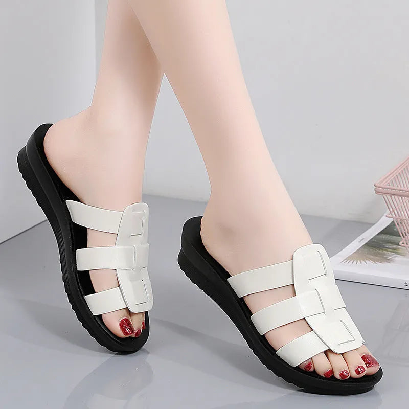 Women's large size flat bottom slippers in beige, black and brown colours with PU leather construction
