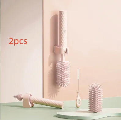Electric baby bottle cleaning brush with rotating silicone head in pink or green colours