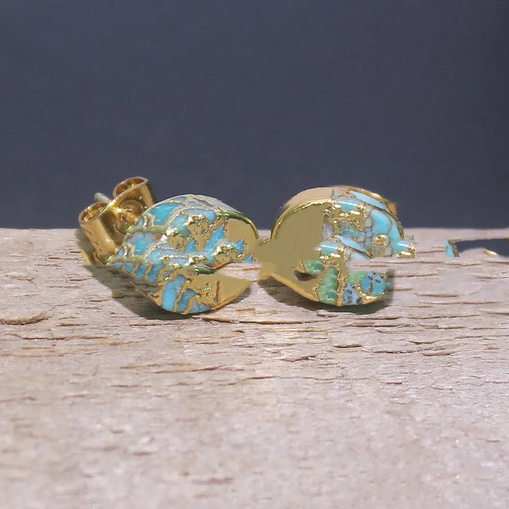 Handmade natural stone bohemian style stud earrings with an irregular organic shape on a grey background.