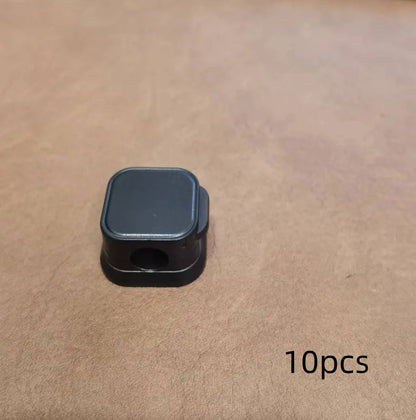 Black and white magnetic cable clips for under desk cable management with adhesive backing