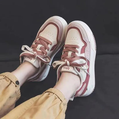 Women's beige and pink low-top sneakers with a rubber sole featuring hidden height increase.
