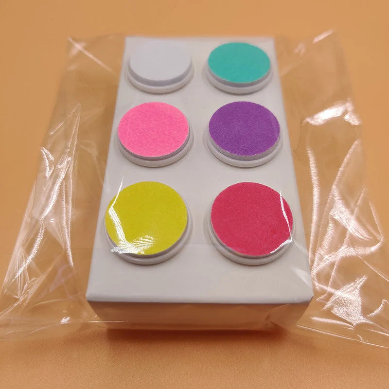 Baby Electric Nail Grinder in red and green with multiple grinding heads