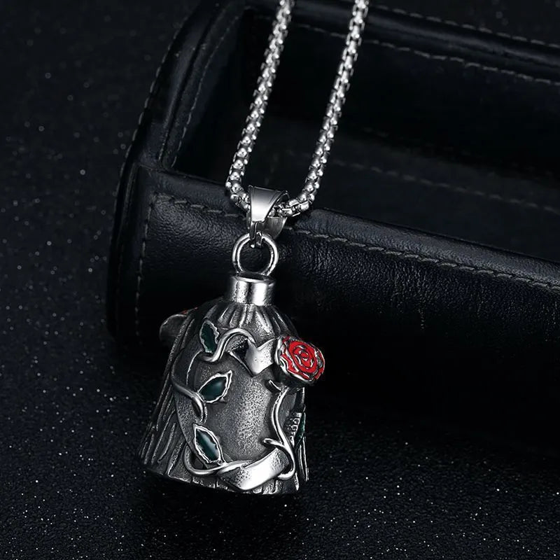 Polished titanium steel vintage motorcycle bell with a red epoxy rose on both sides, shown against a dark background.
