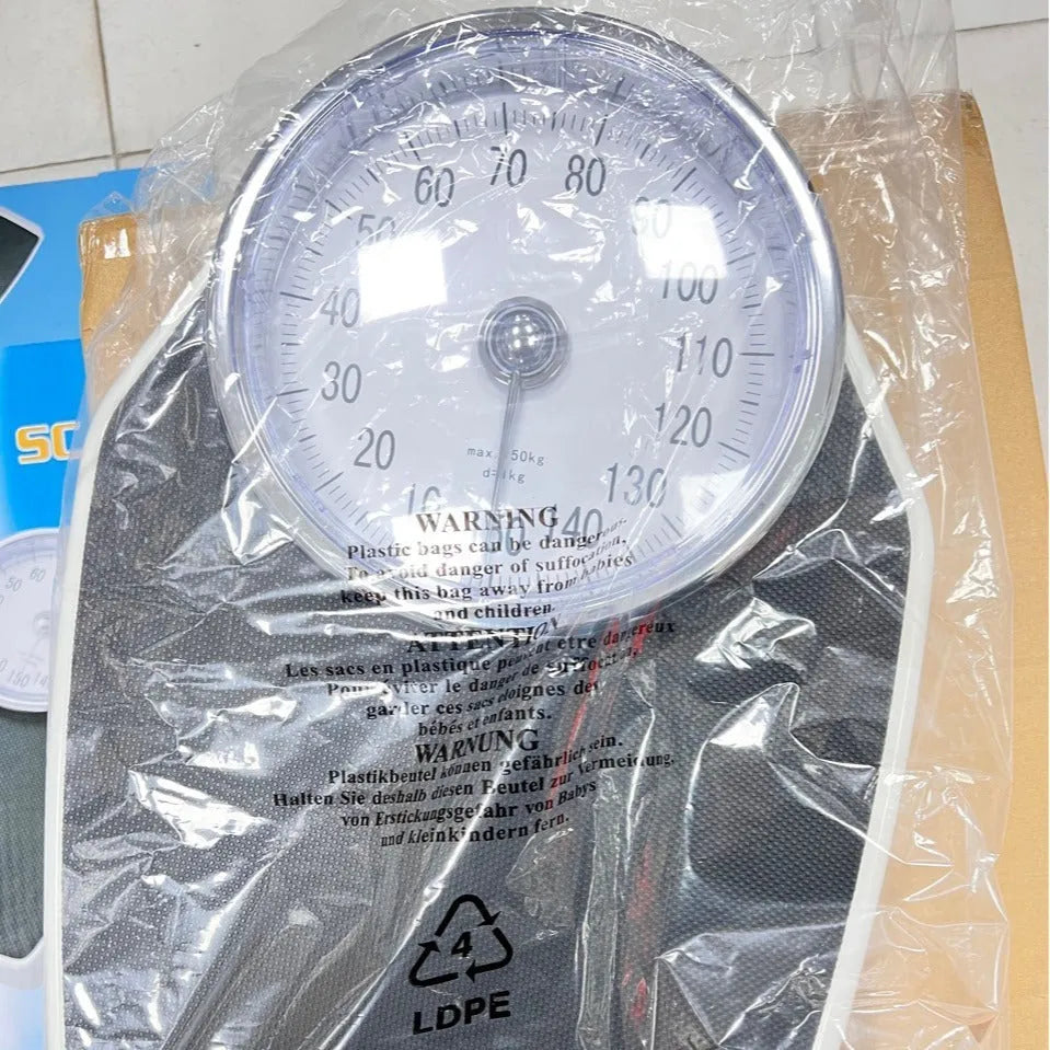 Black mechanical body weight scale with large dial, measuring 47x35x11cm