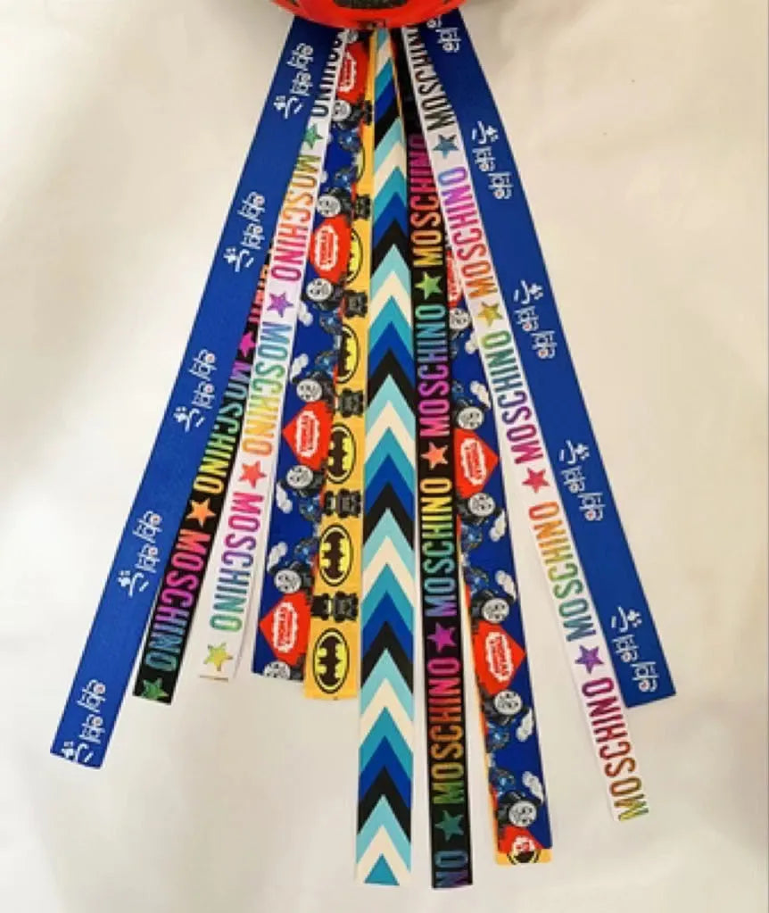 Children's helmet streamer with 60 cm polyester ribbon in colours like apricot and khaki for roller skating and skiing