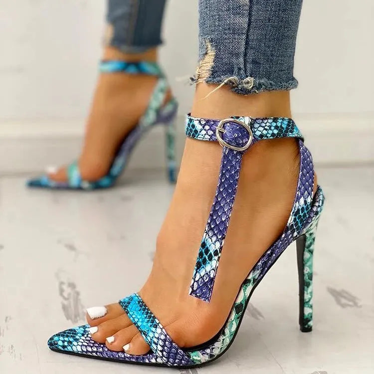Blue women's high heels with a buckle strap and hollow-out pattern on the PU leather upper.