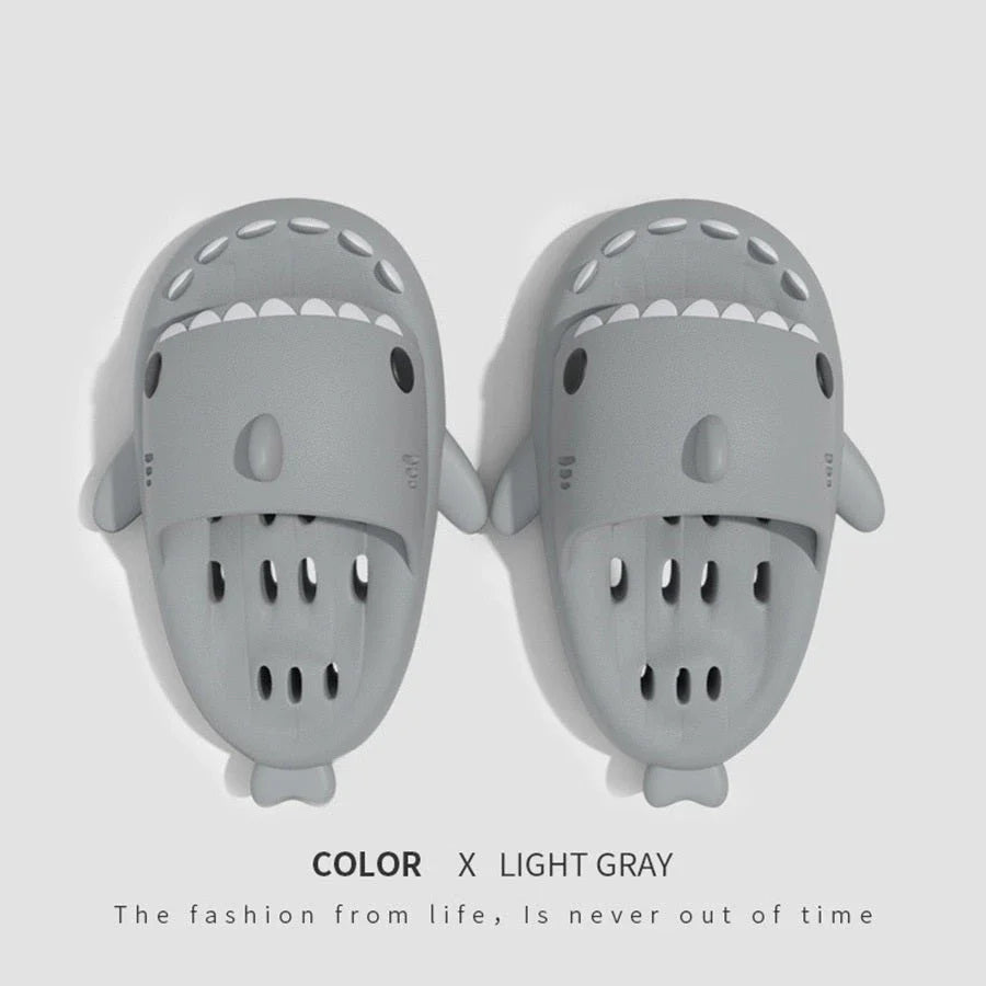 Colorful shark-themed shower slides with drainage holes, designed for comfortable and practical use in the pool or shower.