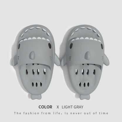 Colorful shark-themed shower slides with drainage holes, designed for comfortable and practical use in the pool or shower.