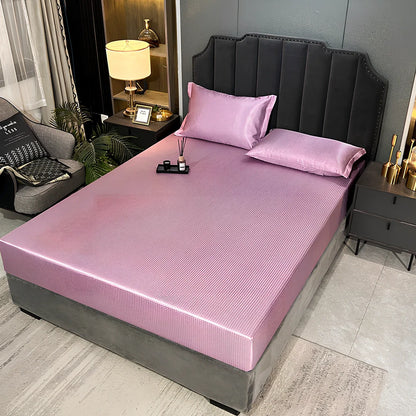 Houndstooth ice silk jacquard fitted three-piece bedding set in ice blue, 180x200cm size with pillowcases on white bed