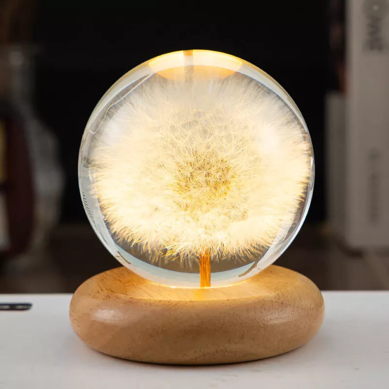 LED Dandelion Crystal Ball Night Light with oak base emitting soft glow