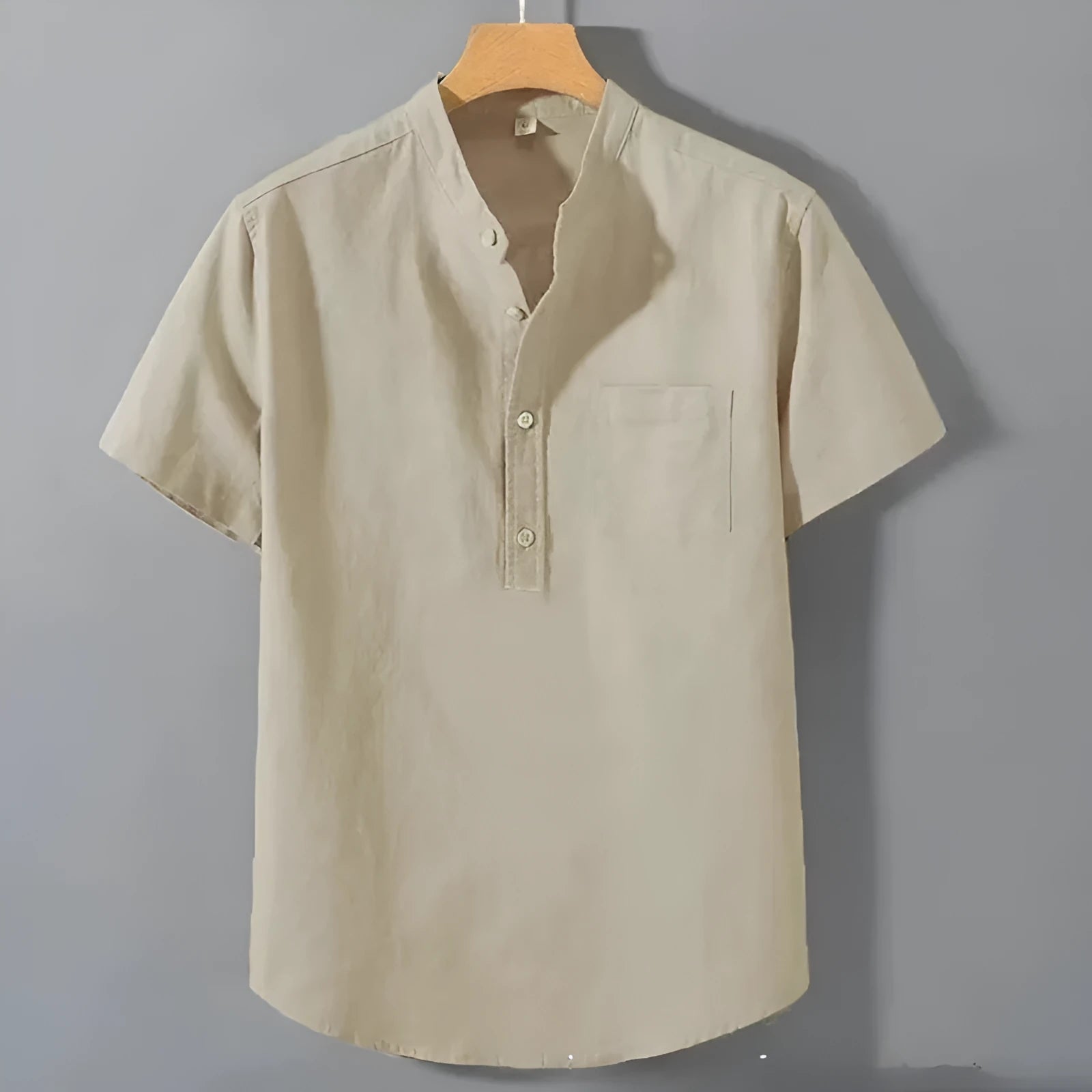 Man wearing a beige loose-fit linen blend casual shirt with a stand collar and short sleeves.