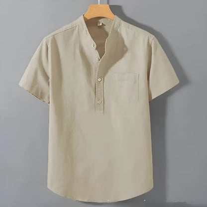 Man wearing a beige loose-fit linen blend casual shirt with a stand collar and short sleeves.