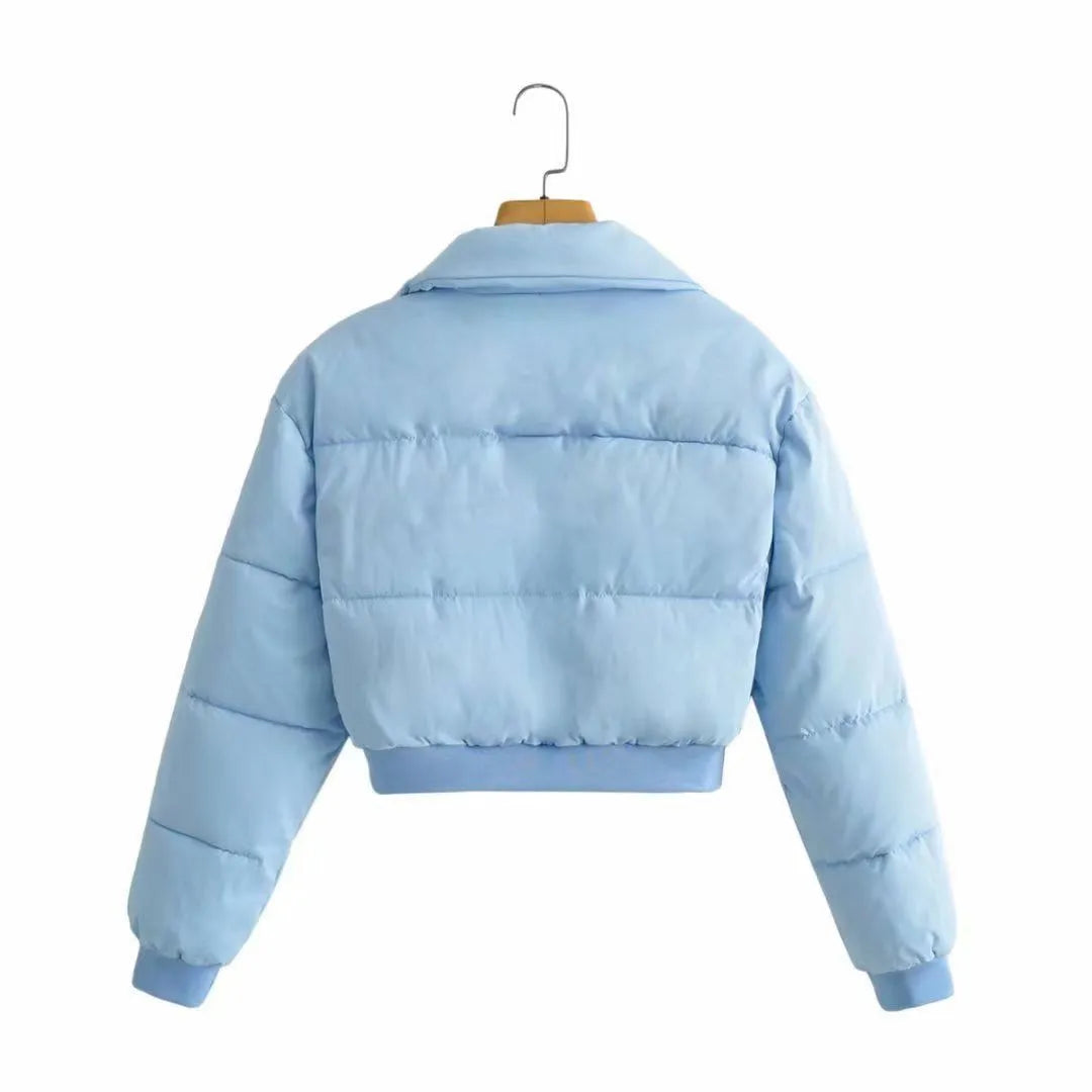 Women's loose-fit long sleeve polyester jacket in blue on a hanger.
