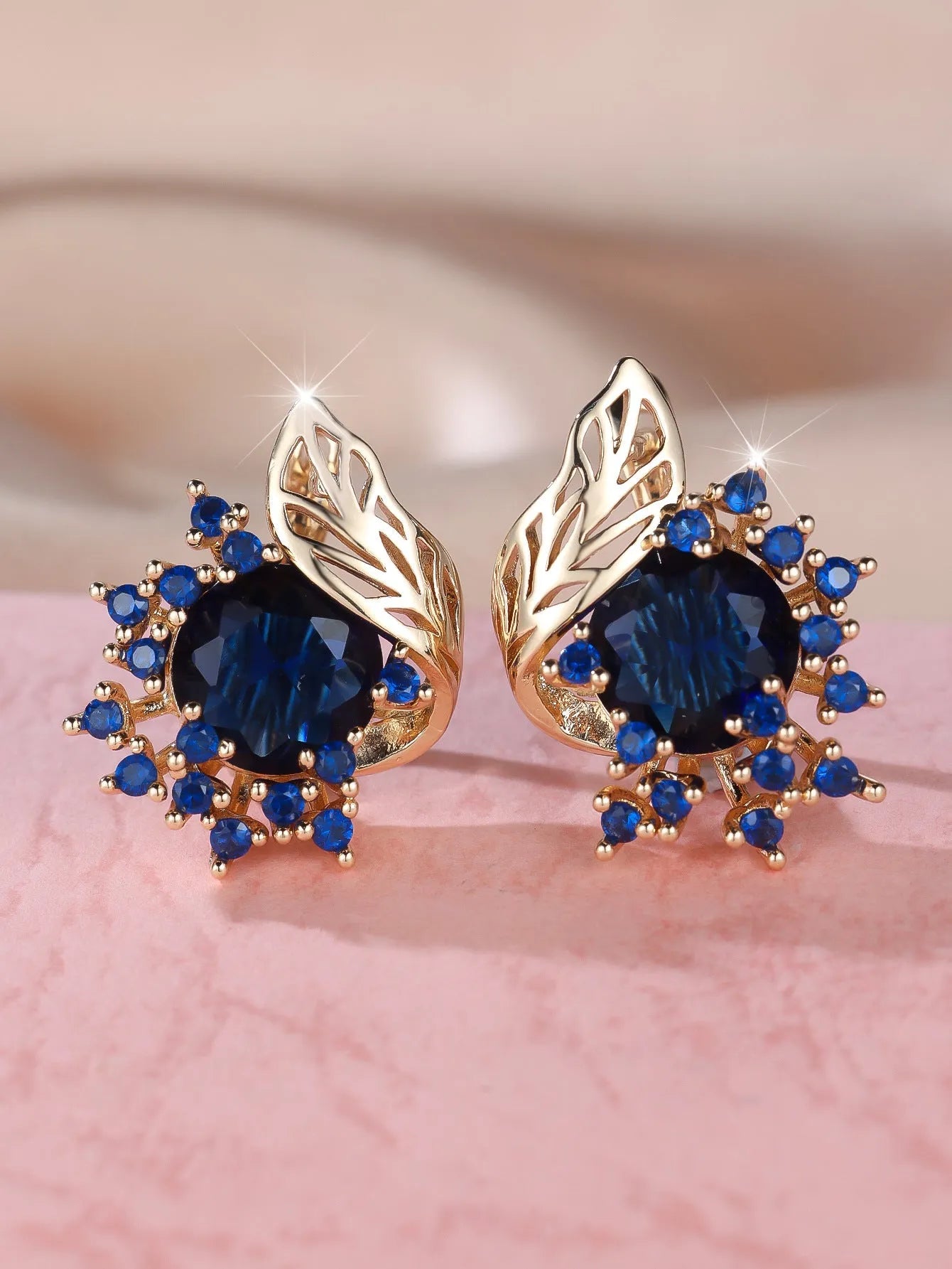 Round flower and feather design earrings in champagne gold with a choice of coloured zircon stones.