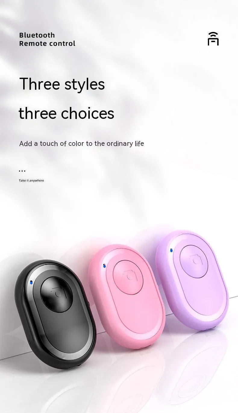 Small black wireless Bluetooth remote control for smartphone camera with self-timer function.
