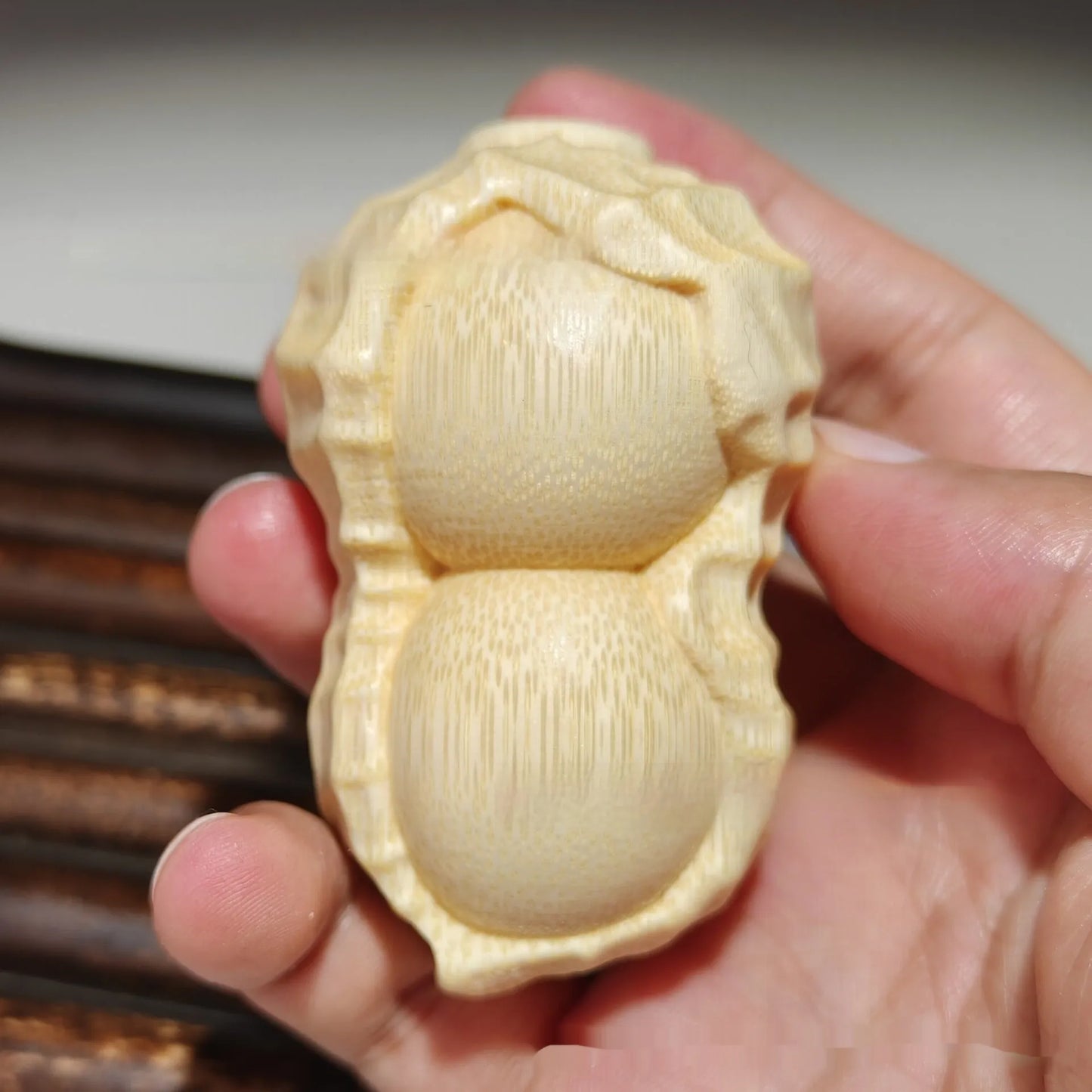 Hand-carved solid bamboo peanut ornament with modern design for gifting and decor
