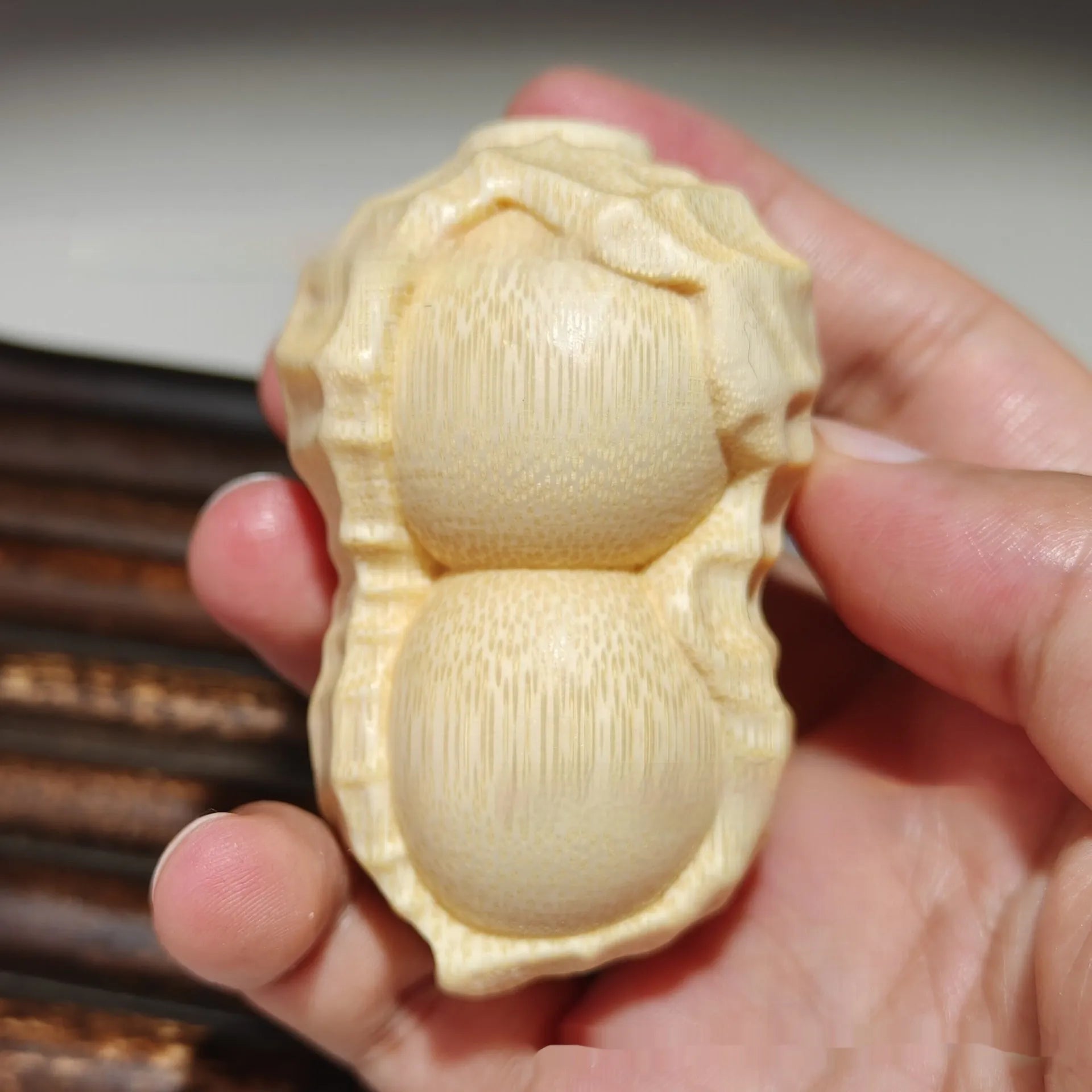 Hand-carved solid bamboo peanut ornament with modern design for gifting and decor