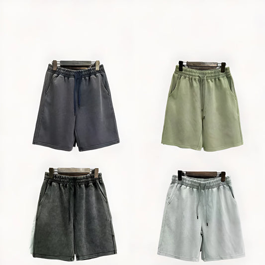 Men's distressed light blue cotton shorts with a loose straight-leg casual fit on a neutral background