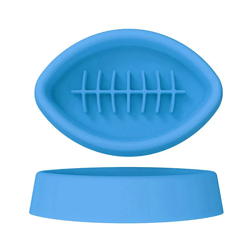 Blue silicone pet slow feed bowl with suction cup base on kitchen floor