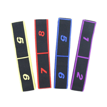 Blue multi-section yoga stretch strap for Pilates and dance exercises on a wooden floor