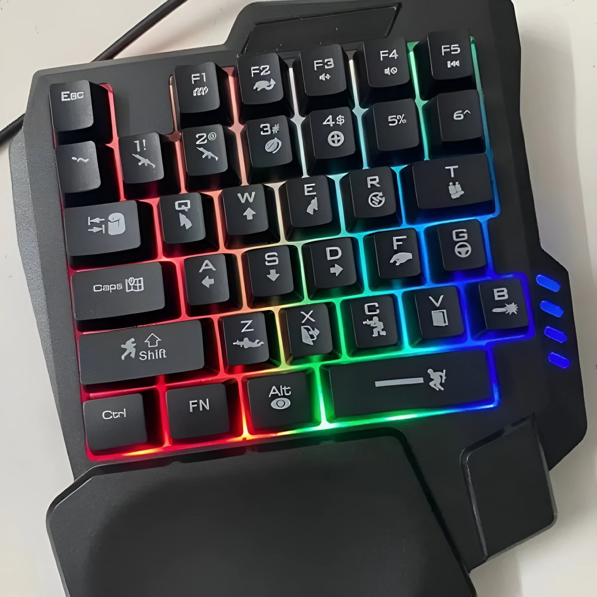Black one-handed mechanical keyboard and mouse set with a 1.5 metre USB cable on a desktop.