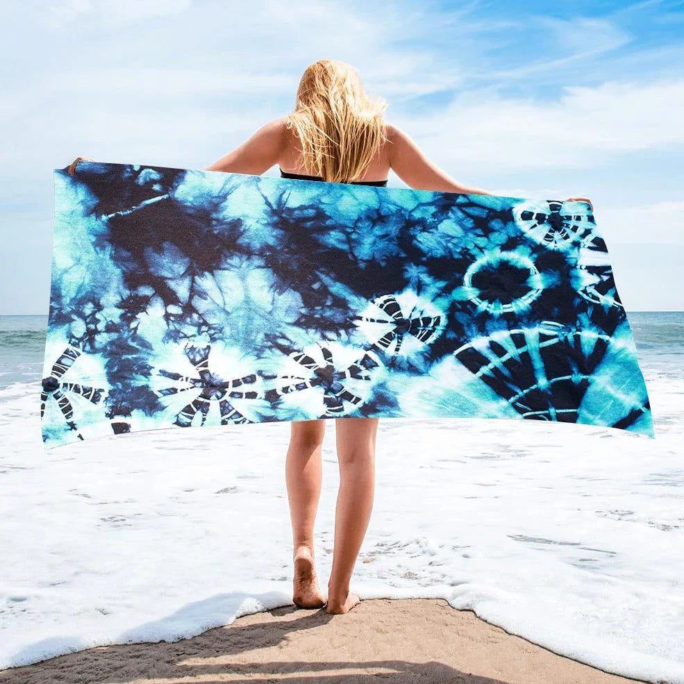 Square beach towel with tie-dye pattern showing superfine fibre texture and vibrant colours