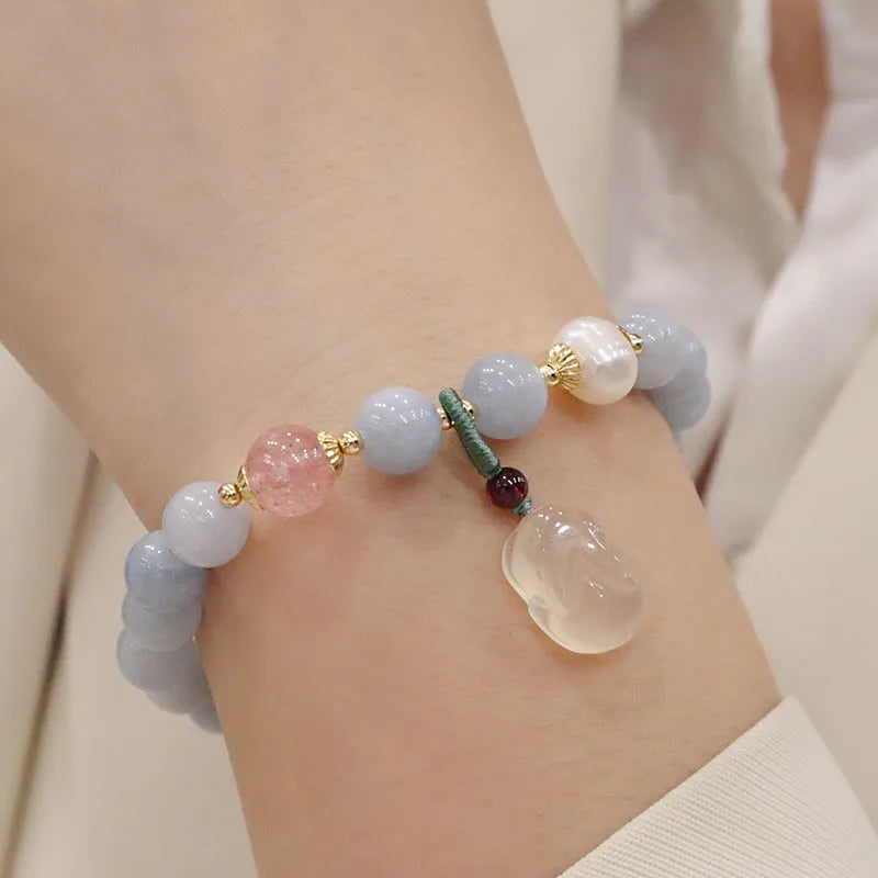 Gold plated women's bracelet with artificial crystal aquamarine chalcedony pendant in climbing cat design